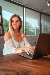 blonde girl working remotely from her computer