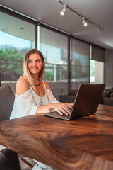 blonde girl working remotely from her computer