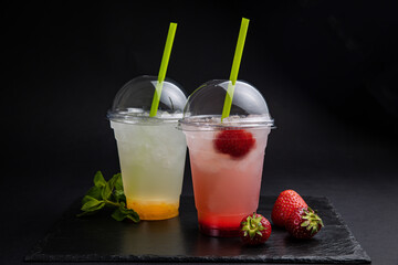 Lemonades in transparent glasses on a black background

