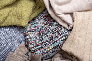 Top view of cozy knitted sweaters. Warm concept