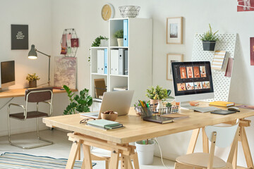 Horizontal image of modern office with workplace of designer with computer monitor on it for retouching photo
