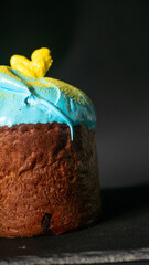 Homemade tasty easter cake with sugar glaze and sprinkles. Homemade easter bread on black background