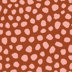 Abstract polka dot animal seamless repeat pattern. Earth tone, vector irregular stains all over surface print on brown background. © MoJX.Studio