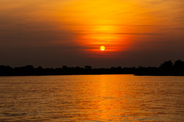 Beautiful sunset in northern Pantanal, world's largest wetlands. Wild brazil, brazilian wildlife and nature, amazing landscape, riverside, by the boat.