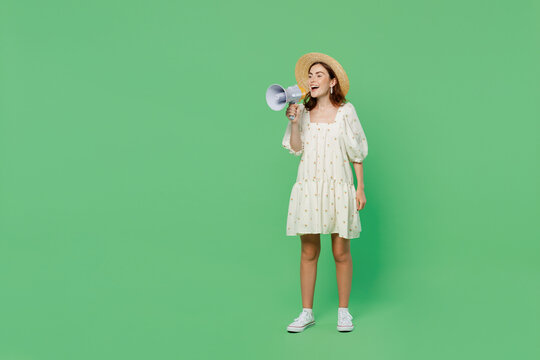 Full body young happy smiling woman she 20s wears white dress hat hold scream in megaphone announces discounts sale Hurry up isolated on plain pastel light green background. People lifestyle concept.
