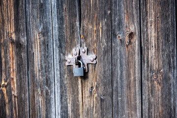 beautiful old lock on a wooden door with forged fragments