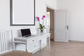 White wooden sideboard with a flower pot, matching chair, lacquered wood carpentry and marble floors