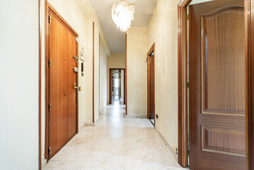 Distributor hallway of a house with dark wood doors and ceramic tile floors