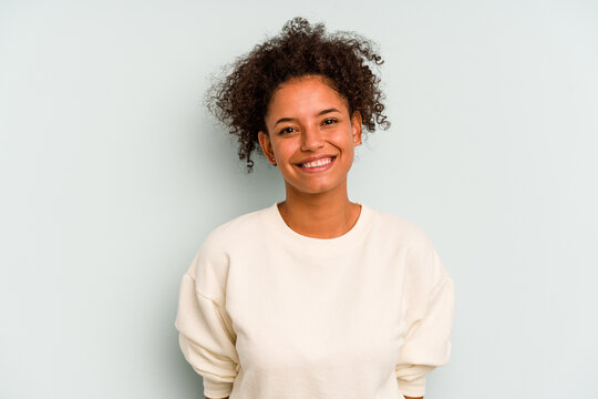 Young Brazilian woman isolated on blue background happy, smiling and cheerful.