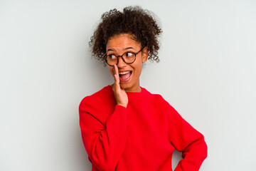 Young Brazilian woman isolated on blue background shouting excited to front.