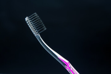 Fototapeta na wymiar toothbrush for cleaning teeth on a dark background. health items