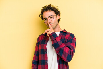 Young caucasian man isolated on yellow background thinking and looking up, being reflective, contemplating, having a fantasy.