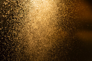 Dark golden bokeh glitter texture background