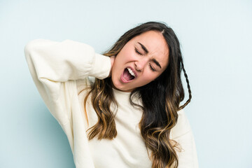 Fototapeta premium Young caucasian woman isolated on blue background suffering neck pain due to sedentary lifestyle.