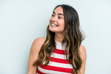 Fototapeta premium Young caucasian woman isolated on blue background relaxed and happy laughing, neck stretched showing teeth.