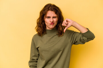 Young caucasian woman isolated on yellow background showing thumb down, disappointment concept.