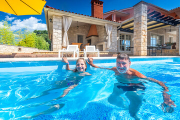 Croatia, Istria, Pula, blonde girl and grandfather at the pool