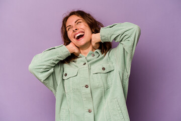 Young caucasian woman isolated on purple background feeling confident, with hands behind the head.