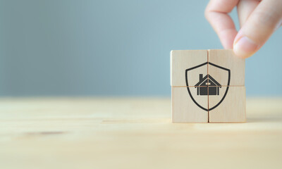 Home protection, insurance, loan, mortgage and buy a real estate concept.  Protection home on wooden cubes on grey background. Stay home stay safe concept. Housing risk insurance banner.