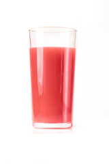 A tall glass with a pink strawberry or cherry juice drink on a white background.
