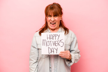 Middle age caucasian woman holding Happy mother’s day placard isolated on pink background...