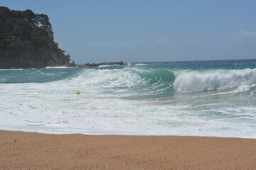 big waves on the beach of Cala Canyelles