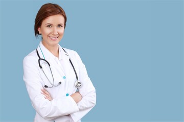 Young happy doctor standing on blue background