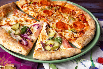 Slices of Chorizo Pizza and Bacon Pizza with pickled cucumbers and onion.