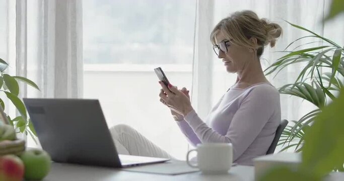 Woman using her smartphone at home