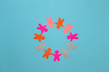 colorful paper people arranged in a circle on a pastel blue background, cheerful colors, all people are equally important, equality