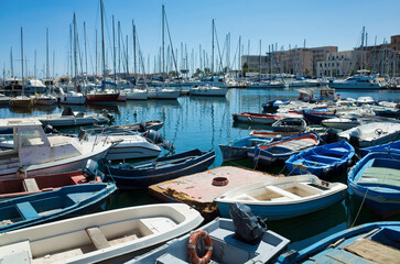 Obraz premium Palermo, Sicily - July 29, 2016: Small port with fishing boats in the center of Mondello