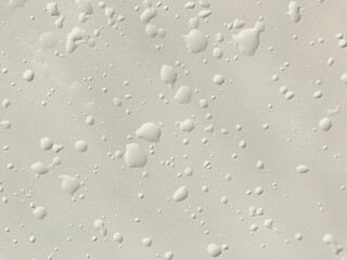 Stock photo smooth matte milky white surface with drops and splashes of water. Background with a perfectly smooth texture splashed with water, for wallpaper, background, design, textures, patterns
