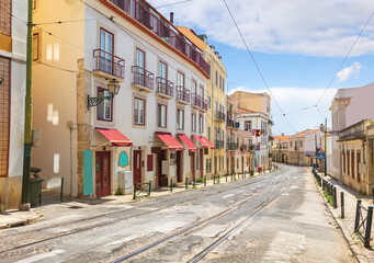 Fototapeta na wymiar A beautiful old Rua das Escolas Gerais street in Alfama. Lisbon, Portugal