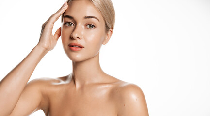 Skin care. Blond young woman, 25 years old, has glowing skin, clean after shower body, touching...