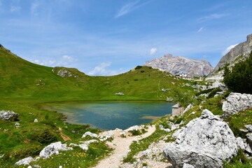 Fototapeta na wymiar View of lake Valparola and Cima Centurines behind the Refugio Passo Valparola in Dolomite Alps in Veneto region and Belluno province in Italy