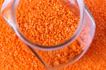 Red lentils in a glass jar.