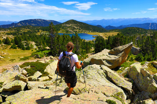 Backpacker man hiking the Pyrenees mountains- beautiful panoramic view