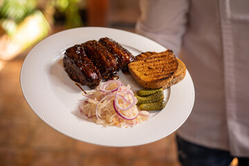 Food. Grilled Meat And Vegetables With Sauce Closeup. Grilles Pork Ribs In Restaurant.
