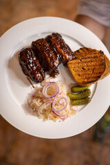 Food. Grilled Meat And Vegetables With Sauce Closeup. Grilles Pork Ribs In Restaurant.