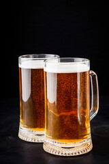 mug of beer and a set of dry fish snacks on a dark background