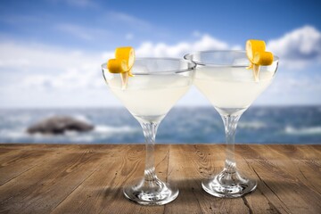 Two glasses with fresh homemade cocktail on a table at summer evening,