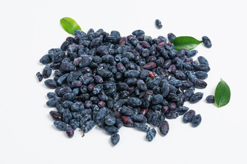 Bunch of fresh blue honeysuckle with green leaves on white background