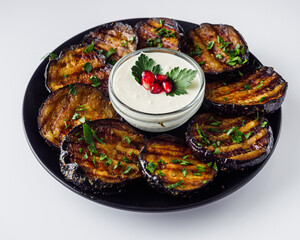 grilled eggplant in Georgian style on a white acrylic background