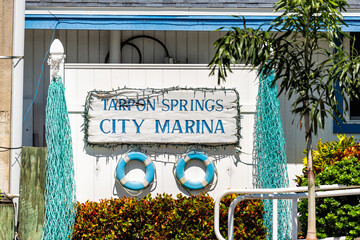Tarpon Springs, Florida colorful blue white Greek European small town sunny day sign for city marina at harbor with nobody