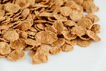 Crispy healthy dry cereal flakes on white background