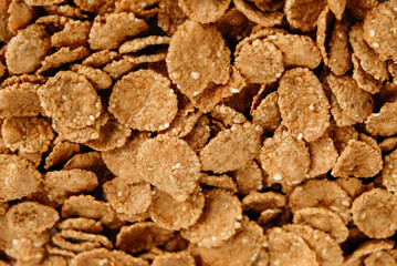 Crispy healthy dry cereal flakes as a background texture