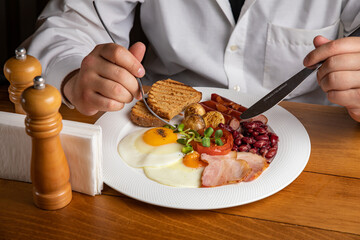 English breakfast on a wooden table in a restaurant

