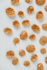 Crispy healthy dry cereal flakes on white background