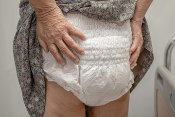 Asian senior or elderly old lady woman patient wearing incontinence diaper in nursing hospital ward, healthy strong medical concept. - obrazy, fototapety, plakaty