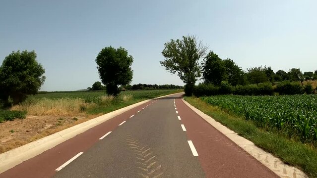 POV Driving on motorcycle on a scenic road in South Limburg in the Netherlands near Bruisterbosch